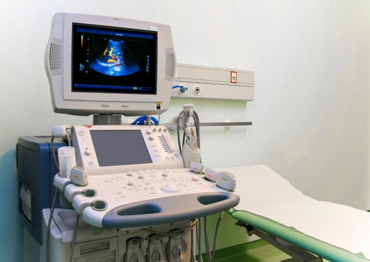 Modern ultrasound machine with control panel and imaging screen in a clinical setting